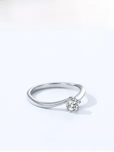 Detail of classic six-prong solitaire ring with a brilliant round cut zircon on silver band