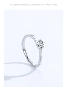 Macro detail of S925 silver ring with bypass band and six-prong zircon setting