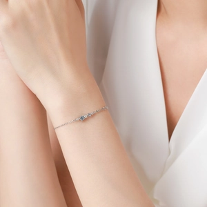 Elegant S925 sterling silver chain bracelet with light blue diamond accents on a model's wrist