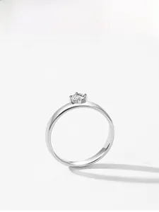 Detailed top view of a sparkling round-cut diamond solitaire ring with classic four-prong setting