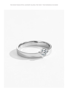 Macro detail of a classic S925 sterling silver ring with a sparkling four-prong diamond setting