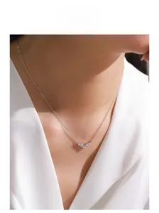 Close-up of S925 sterling silver V-shaped dolphin tail necklace with sparkling zircons