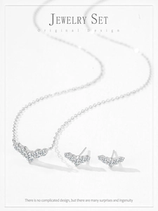 Detailed view of sterling silver necklace and earrings set with shimmering zircon stones