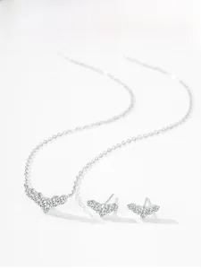 Close-up of S925 sterling silver dolphin tail necklace and earrings set with zircons
