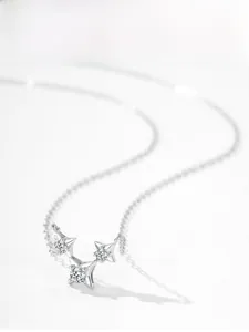Detail of S925 sterling silver necklace featuring three sparkling star-shaped pendants
