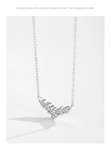 Detail of S925 sterling silver dolphin tail necklace with five sparkling zircon stones