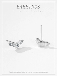 Macro shot of V-shaped S925 sterling silver stud earrings with five sparkling cubic zirconia
