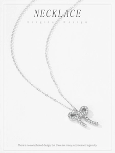 Detailed close-up of S925 silver necklace featuring a bow pendant with pavé zircon stones