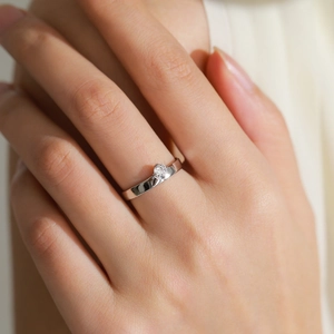 S925 sterling silver bypass ring with a brilliant round diamond on a model's finger
