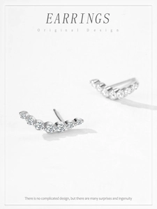 Macro shot of S925 silver curved crawler earrings with seven graduated round zircons