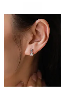 Close-up of model wearing silver S925 four-point star earrings with zircon stones