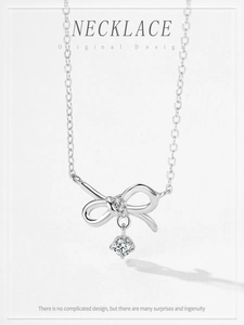 Detailed macro of S925 sterling silver bow pendant necklace with sparkling zircons