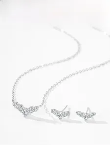 Detailed view of silver V-shaped jewelry set with necklace and zircon stud earrings