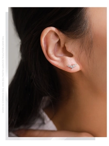 Detail of S925 sterling silver V-shape stud earring with pavé zircon on model ear