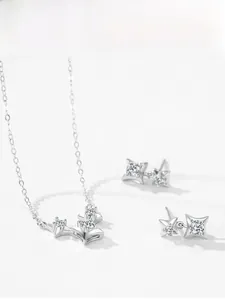 Macro shot of S925 sterling silver four-point star necklace and earrings with zircon