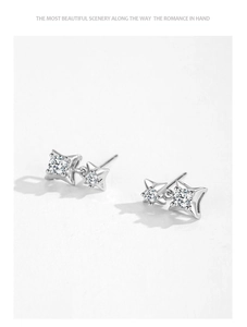Close-up of S925 sterling silver star earrings featuring sparkling round-cut zircon stones