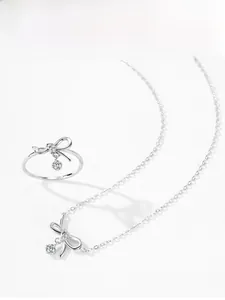 Detailed view of S925 silver bow jewelry set with sparkling cubic zirconia stones