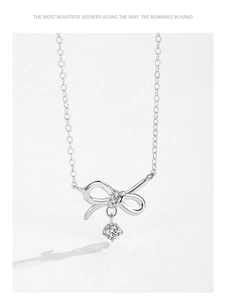 Detail of S925 sterling silver bow necklace with micro-pave cubic zirconia and round center stone