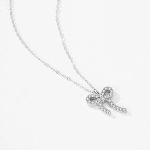 S925 sterling silver bow pendant necklace with shimmering zircon stones on white background