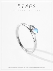 Detail of 925 sterling silver ring featuring a blue moonstone and clear zircon gem