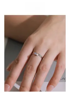 Detailed view of dual moonstone and zircon gemstones on a minimalist silver ring