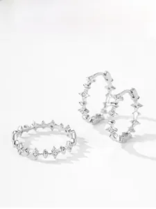 Detailed view of S925 sterling silver star-shaped earrings and ring with sparkling zircons