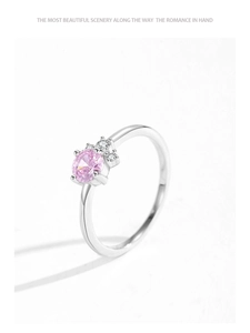 Detail of S925 sterling silver ring with a round pink zircon and side accents