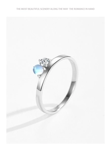 Close-up of a 925 silver ring featuring a round zircon and light blue moonstone inlay