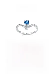 Macro shot of S925 sterling silver ring with blue zircon and pavé white diamonds
