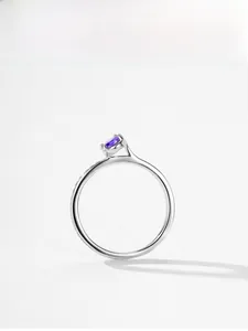 Macro shot of an elegant S925 silver ring featuring a round purple zircon gemstone