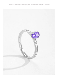 Detail of S925 silver ring featuring purple oval gemstone and textured lattice band