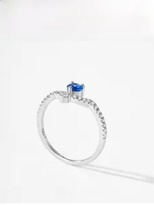 Macro shot of S925 sterling silver ring with blue zircon and delicate crystal accents