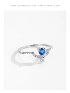 Close-up of V-shaped S925 silver ring featuring a round blue zircon and tiny diamonds