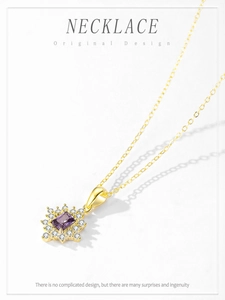 Macro shot of silver sun flower pendant necklace with purple crystal and zirconia