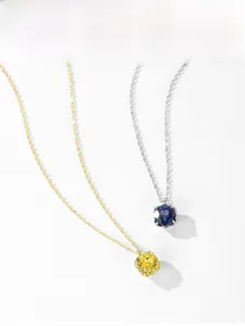 Close-up of S925 silver necklaces with round-cut blue and yellow gems in claw setting