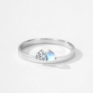 Elegant 925 sterling silver ring featuring a polished band with moonstone and zirconia