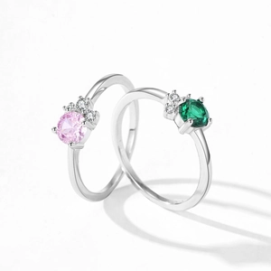 S925 sterling silver rings with round emerald green and pink zircon stones on white background