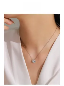 Gros plan du collier en argent S925 avec pendentif gemme bleue porté par un mannequin