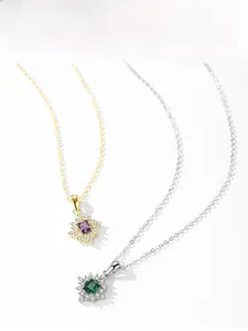 Detail of luxury S925 silver necklaces with sun-flower pendants in purple and green crystals