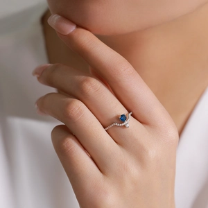 Elegant S925 sterling silver V-shaped ring with round blue gemstone and micro-pave diamonds