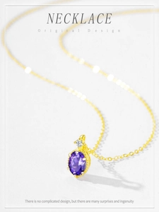 Macro shot of gold oval purple crystal pendant necklace with small white zircon detail