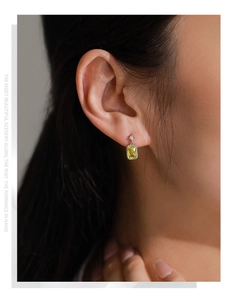 Macro detail of S925 silver earring featuring a square yellow zircon and star stud