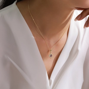 Elegant gold necklace with purple gemstone sunflower pendant on model, 80-100 characters long