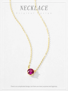 Detail of 14K gold plated S925 silver necklace with a rose red zircon stone pendant