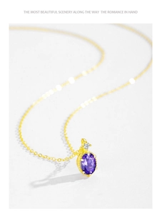 Detail of 14K gold plated silver necklace with oval violet crystal and zircon stone