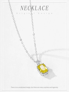 Macro detail of S925 silver necklace with rectangular yellow zircon pendant