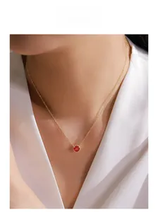 Model wearing a delicate 14K gold plated S925 silver necklace with a ruby red zircon pendant