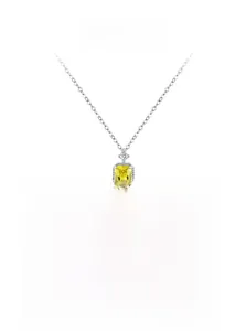 Macro shot of S925 silver necklace with emerald cut yellow zircon pendant and small diamonds