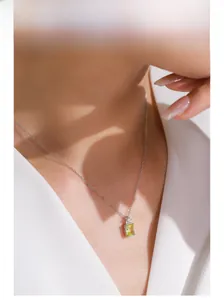 Close-up of S925 silver necklace with lemon yellow zircon pendant on model neck