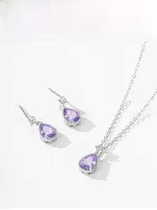 Macro view of pear-cut purple crystal pendant and matching earrings in S925 silver